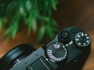 High angle closeup of the mode dial of a camera on the table under the lights