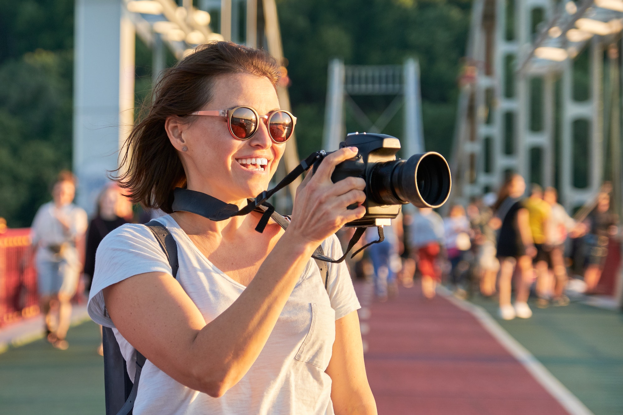 Mature woman photographer with camera taking photo picture