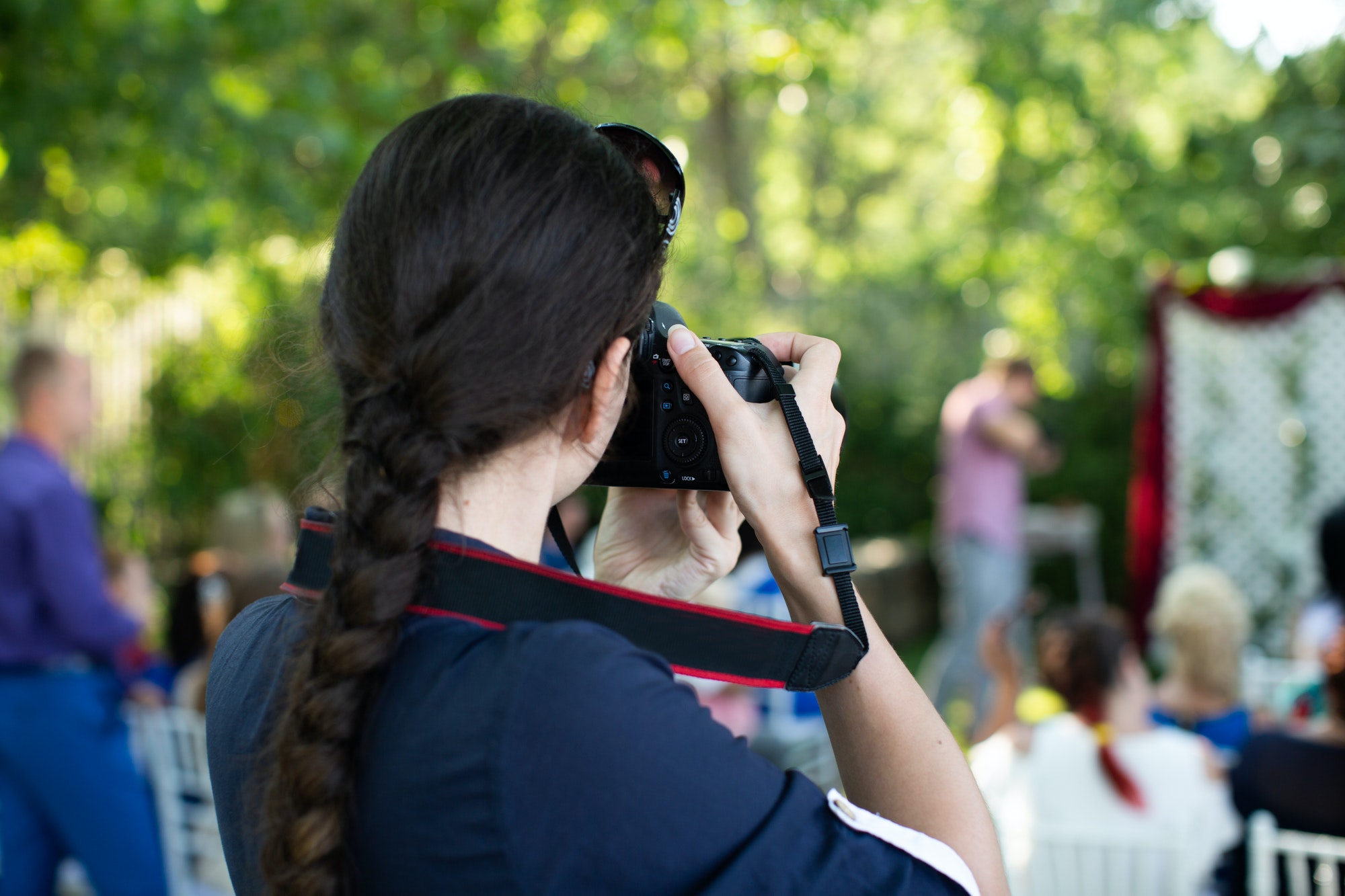 Photographer is a woman photographing a wedding ceremony